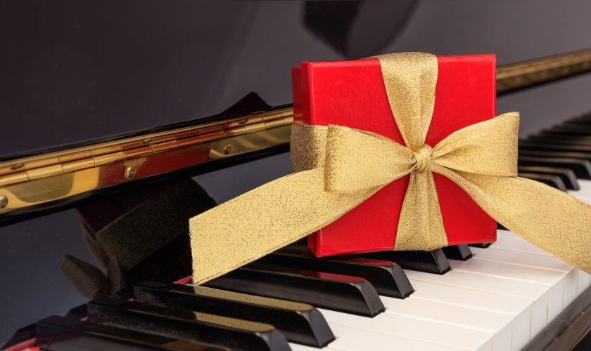 Red gift box on piano keyboard